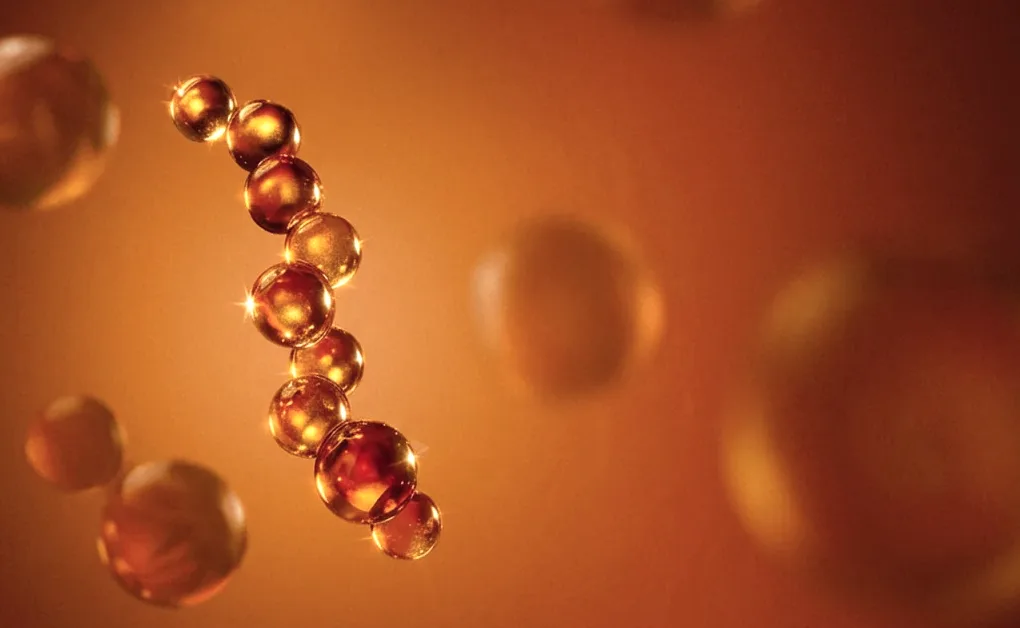 Amber peptide molecules glowing against an orange backdrop